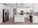 Bright kitchen featuring white cabinets, a center island, stainless steel appliances, and modern pendant lighting at 18486 E Dario Rd, Gold Canyon, AZ 85118
