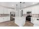 Beautiful open kitchen with white cabinetry, a center island, stainless steel appliances, and stylish backsplash at 18486 E Dario Rd, Gold Canyon, AZ 85118