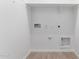 Bright laundry room with hookups and white walls and tile floors provides convenience and functionality at 18486 E Dario Rd, Gold Canyon, AZ 85118