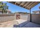 Cozy back patio area enclosed by stucco walls and a wooden gate, perfect for outdoor relaxation at 1961 N Hartford St # 1055, Chandler, AZ 85225