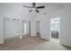 Bedroom with bathroom and mirrored closet doors, ceiling fan and neutral carpet at 1961 N Hartford St # 1055, Chandler, AZ 85225