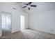 Bedroom with access to bathroom featuring doorway and neutral carpet and ceiling fan at 1961 N Hartford St # 1055, Chandler, AZ 85225
