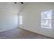 Well-lit bedroom featuring two windows, vaulted ceiling with ceiling fan, and neutral carpeting at 1961 N Hartford St # 1055, Chandler, AZ 85225