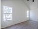 Bright bedroom with neutral carpet, vaulted ceiling, and natural light from two windows at 1961 N Hartford St # 1055, Chandler, AZ 85225