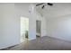 Bedroom featuring neutral carpet, ceiling fan, and access to bathroom with white tiled shower at 1961 N Hartford St # 1055, Chandler, AZ 85225