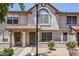 Inviting townhome featuring a light-colored exterior with arched window and tidy front garden at 1961 N Hartford St # 1055, Chandler, AZ 85225