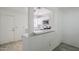 This updated kitchen features white cabinets, stainless appliances and a breakfast bar at 1961 N Hartford St # 1055, Chandler, AZ 85225