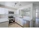 Updated kitchen features stainless appliances, white cabinets and a pass through to the dining area at 1961 N Hartford St # 1055, Chandler, AZ 85225