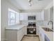 Updated kitchen features stainless steel appliances, white cabinets and lots of light at 1961 N Hartford St # 1055, Chandler, AZ 85225