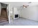 Bright living room with fireplace, fan and staircase at 1961 N Hartford St # 1055, Chandler, AZ 85225