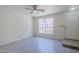 Open-concept living area with fan, window, and smooth flooring at 1961 N Hartford St # 1055, Chandler, AZ 85225
