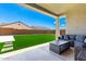 Back patio with a covered seating area, artificial grass, and block fence at 20451 E Via De Colina --, Queen Creek, AZ 85142