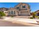 Charming two-story home with neutral stucco, stone accents, and a three-car garage at 20451 E Via De Colina --, Queen Creek, AZ 85142