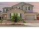 Charming home with neutral stucco, stone accents, and a gray three-car garage at 20451 E Via De Colina --, Queen Creek, AZ 85142
