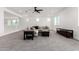 Spacious living room featuring neutral walls, plush carpeting, natural light, and a modern ceiling fan at 20451 E Via De Colina --, Queen Creek, AZ 85142