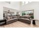 Open-concept floorplan with a large sofa, wood floors, and bright natural light at 20451 E Via De Colina --, Queen Creek, AZ 85142