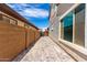 Paver side yard with a view of the gate to the backyard and home with white framed windows at 20451 E Via De Colina --, Queen Creek, AZ 85142