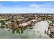 Aerial view showcasing lakefront homes with lush landscaping on a sunny day at 2128 E Clipper Ln, Gilbert, AZ 85234
