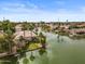 Aerial view of a lovely waterfront home with a manicured lawn and private boat dock at 2128 E Clipper Ln, Gilbert, AZ 85234