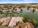 Aerial view of lakefront community with luxurious homes, and mature landscaping at 2128 E Clipper Ln, Gilbert, AZ 85234