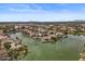 Beautiful aerial view of a lakefront community with well-maintained homes and lush landscaping at 2128 E Clipper Ln, Gilbert, AZ 85234