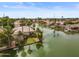 Lovely aerial view of a home on a waterway with well-maintained landscaping and a private dock at 2128 E Clipper Ln, Gilbert, AZ 85234