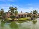 Aerial view of a beautiful waterfront home with lush landscaping and a private boat dock at 2128 E Clipper Ln, Gilbert, AZ 85234