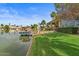 Picturesque backyard with private boat dock and lush lawn, offering stunning views of the tranquil lake at 2128 E Clipper Ln, Gilbert, AZ 85234