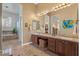 Bathroom featuring a double vanity, large mirror, accent lighting, and tiled flooring at 2128 E Clipper Ln, Gilbert, AZ 85234