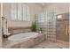 Well-lit bathroom featuring a tub and frosted glass shower enclosure at 2128 E Clipper Ln, Gilbert, AZ 85234