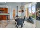 Dining area with wood table, seating for six, large window with natural light, and bar with wine cooler at 2128 E Clipper Ln, Gilbert, AZ 85234