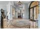 Expansive foyer with elegant marble flooring, custom area rug, and grand architectural details at 2128 E Clipper Ln, Gilbert, AZ 85234