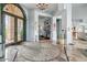 Grand foyer showcasing decorative tile flooring, soaring ceilings, and an ornate wrought iron front door at 2128 E Clipper Ln, Gilbert, AZ 85234