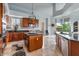 Charming kitchen with wood cabinets, granite countertops, a functional island, and an adjacent breakfast area at 2128 E Clipper Ln, Gilbert, AZ 85234