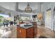 Open-concept kitchen with granite island, stainless appliances, wood cabinetry, and breakfast nook overlooking water view at 2128 E Clipper Ln, Gilbert, AZ 85234