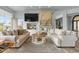 Bright, open living room featuring a decorative fireplace and access to the outdoor lake at 2128 E Clipper Ln, Gilbert, AZ 85234