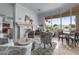 Bright and airy living room with a fireplace, comfortable seating, and scenic lake views from large windows at 2128 E Clipper Ln, Gilbert, AZ 85234