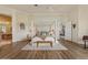 Bright main bedroom features hardwood floors, ceiling fan, four-poster bed, and access to the bathroom suite at 2128 E Clipper Ln, Gilbert, AZ 85234