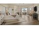 Comfortable main bedroom suite features hardwood floors, a ceiling fan, and expansive windows for natural light at 2128 E Clipper Ln, Gilbert, AZ 85234