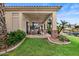 Inviting covered patio featuring comfortable seating, stone accents, and views of the serene waterfront at 2128 E Clipper Ln, Gilbert, AZ 85234