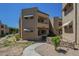 Exterior view of building, showcasing stucco, awnings, and landscaping at 2228 N 52 St # 213, Phoenix, AZ 85008