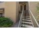 Exterior steps lead to front doors with neutral stucco and balcony above at 2228 N 52 St # 213, Phoenix, AZ 85008
