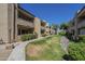 Exterior view of residential buildings with neat landscaping and pathways, ideal for evening walks and enjoying the scenery at 2228 N 52 St # 213, Phoenix, AZ 85008