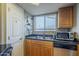 Kitchen featuring a double sink, stainless steel dishwasher, and ample natural light from the window at 2228 N 52 St # 213, Phoenix, AZ 85008