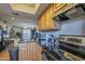 Kitchen overlooking living area features stainless appliances, wood cabinets, and granite countertops at 2228 N 52 St # 213, Phoenix, AZ 85008