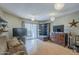 Bright living room features sliding door access to outdoor balcony, neutral paint and wood-look flooring at 2228 N 52 St # 213, Phoenix, AZ 85008
