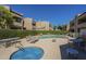 Community pool area with lounge chairs, tables, and manicured hedges in a well-maintained complex at 2228 N 52 St # 213, Phoenix, AZ 85008