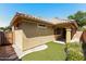 Exterior side and backyard with covered patio, block wall, and low maintenance turf at 2475 E Vermont Dr, Gilbert, AZ 85295