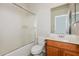 Bathroom featuring shower over tub with glass screen and vanity with white counter at 2475 E Vermont Dr, Gilbert, AZ 85295