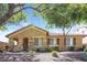 Inviting single-story home featuring stone accents, desert landscaping, and a welcoming covered entryway at 2475 E Vermont Dr, Gilbert, AZ 85295